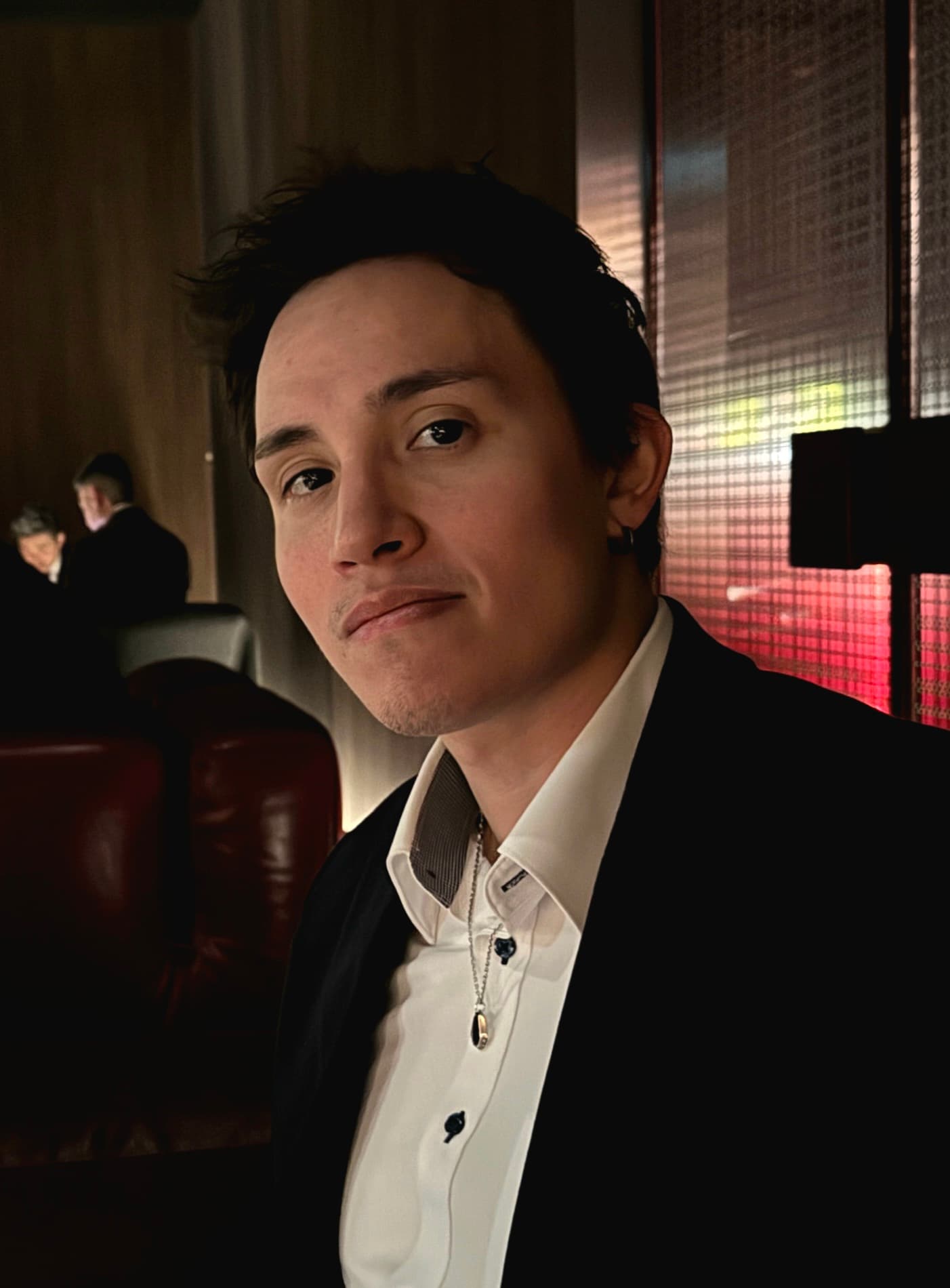 A professional portrait of David De la Cruz